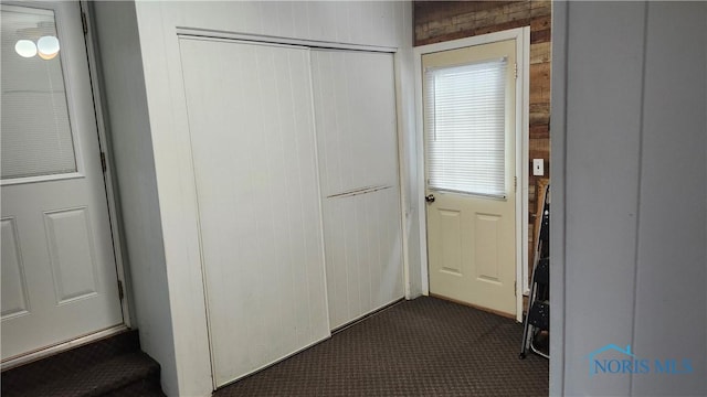 interior space featuring dark carpet