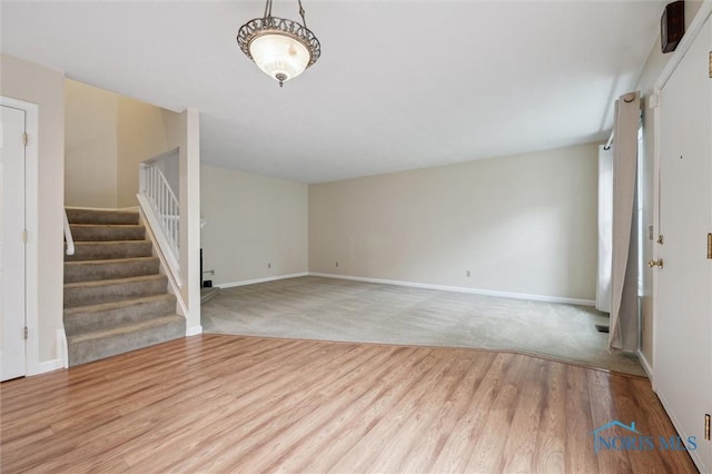 5718 Aspen Dr Unit 15, Toledo, OH 43615 - unfurnished living room with baseboards, stairs, and wood finished floors