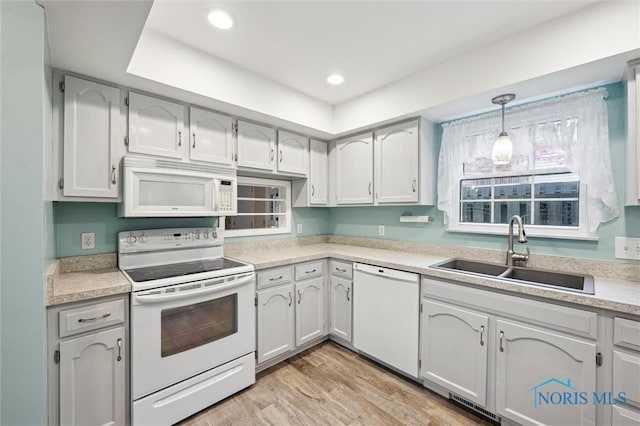 5718 Aspen Dr Unit 15, Toledo, OH 43615 - kitchen featuring decorative light fixtures, a sink, light countertops, white appliances, and light wood-style flooring