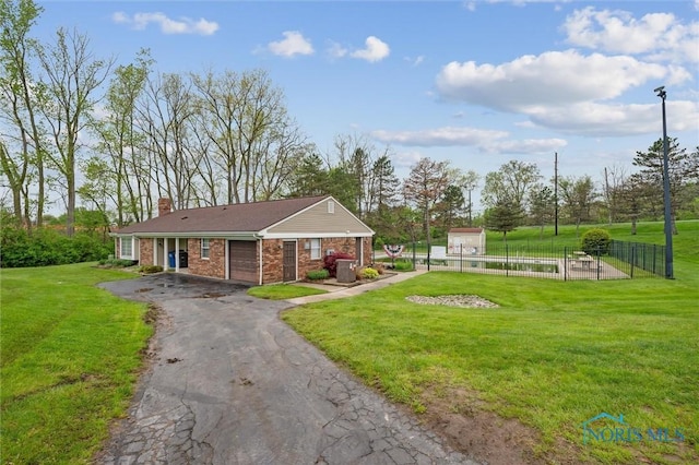 5718 Aspen Dr Unit 15, Toledo, OH 43615 - exterior space with a yard, fence, driveway, and a garage