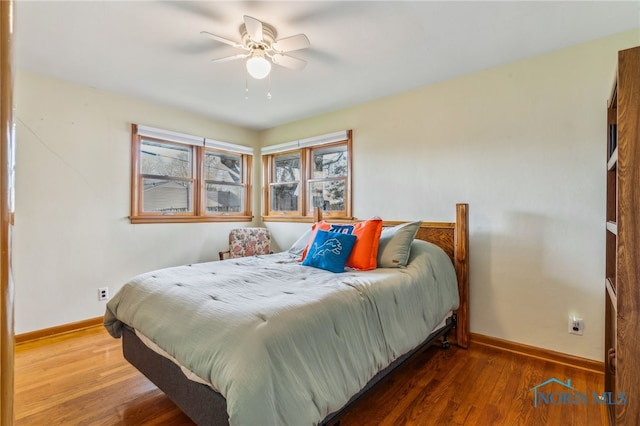 bedroom with baseboards, a ceiling fan, and wood finished floors