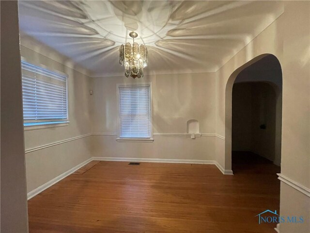 3721 Kershaw Ave, Toledo, OH 43613 - empty room featuring wood finished floors, arched walkways, and baseboards