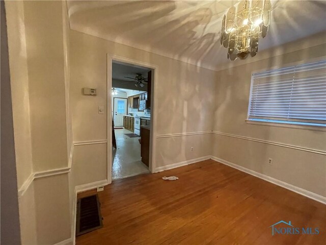 3721 Kershaw Ave, Toledo, OH 43613 - spare room featuring a chandelier, wood finished floors, and baseboards