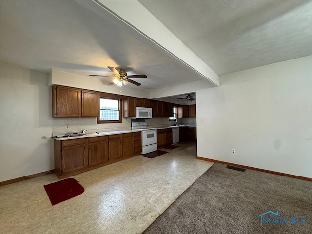 3721 Kershaw Ave, Toledo, OH 43613 - kitchen with white appliances, baseboards, a ceiling fan, light countertops, and a sink