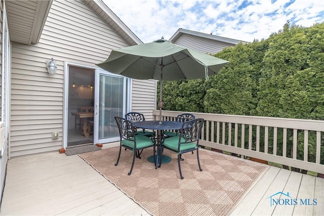 wooden terrace with outdoor dining area