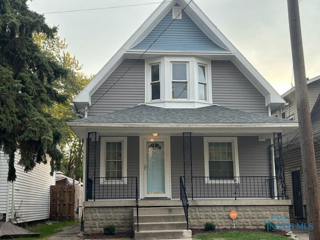 419 Spencer St, Toledo, OH 43609 - view of front of property with fence, a porch, and a shingled roof