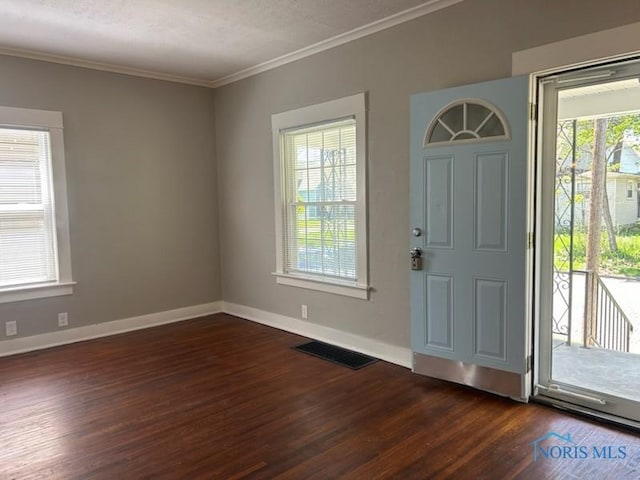 419 Spencer St, Toledo, OH 43609 - foyer entrance featuring crown molding, baseboards, and dark wood-style flooring