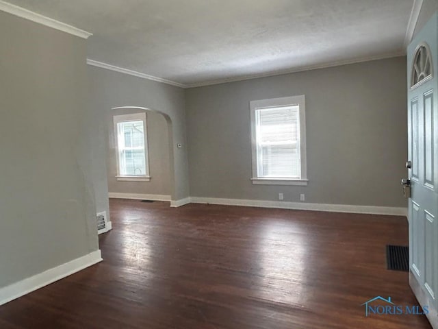 419 Spencer St, Toledo, OH 43609 - unfurnished room featuring arched walkways, crown molding, and plenty of natural light