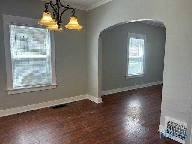 419 Spencer St, Toledo, OH 43609 - empty room featuring arched walkways, visible vents, crown molding, and hardwood / wood-style flooring