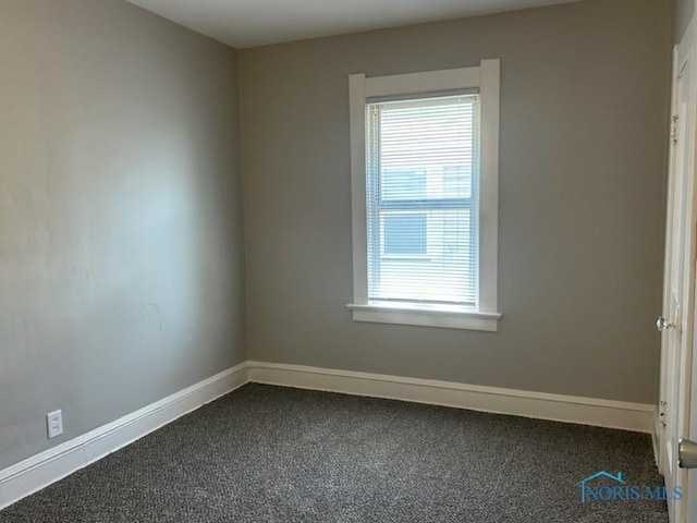 419 Spencer St, Toledo, OH 43609 - unfurnished room with dark colored carpet and baseboards