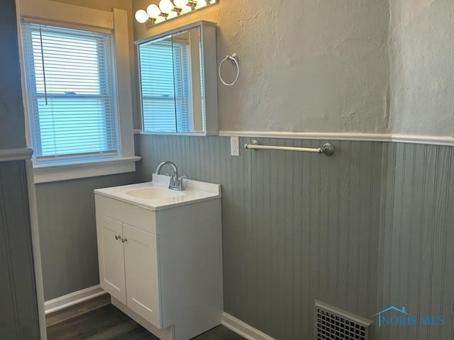 419 Spencer St, Toledo, OH 43609 - bathroom with vanity, a wainscoted wall, wood finished floors, and visible vents