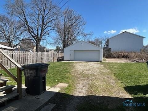 419 Spencer St, Toledo, OH 43609 - view of yard featuring fence, an outbuilding, and a garage