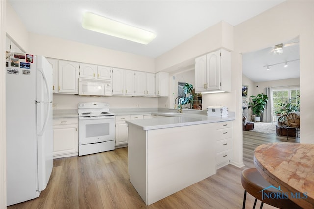 kitchen featuring white cabinets, light countertops, white appliances, and light wood-style flooring