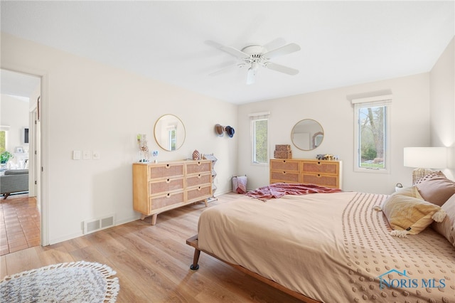 bedroom with visible vents, ceiling fan, and wood finished floors