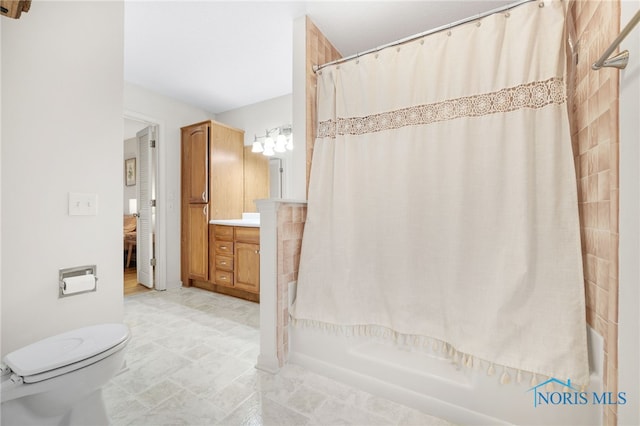 full bathroom with vanity, a shower with shower curtain, and toilet