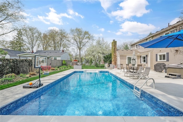 view of pool featuring a patio, a fenced in pool, a hot tub, fence, and a grill