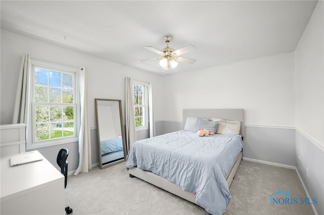 bedroom featuring baseboards, carpet floors, and multiple windows