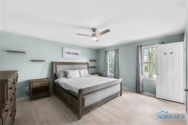 bedroom with crown molding, ceiling fan, baseboards, and light wood-style floors
