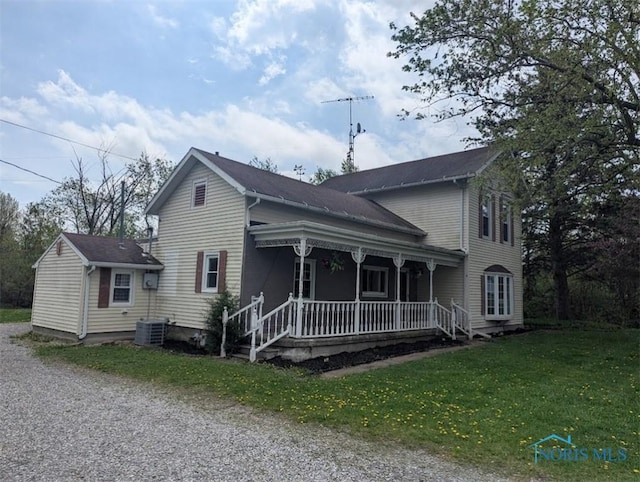 view of front of property with covered porch and a front yard