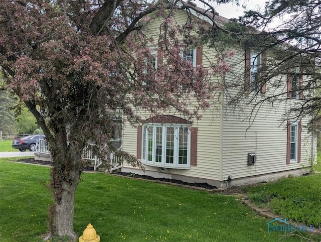 view of home's exterior with a yard