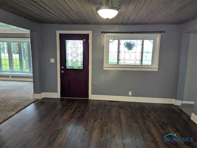 entrance foyer featuring wood ceiling, baseboards, and dark wood finished floors