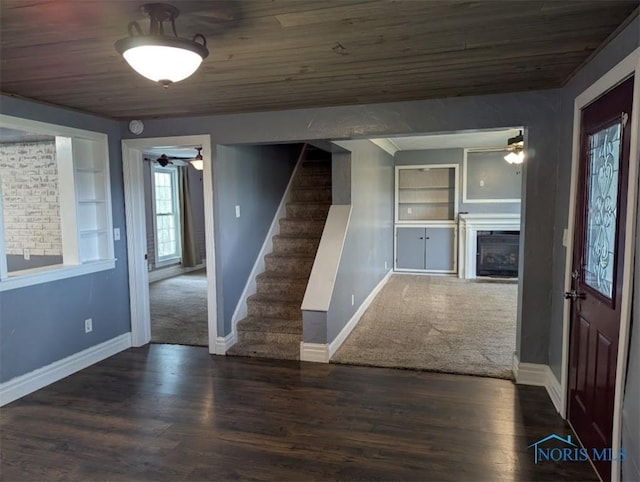 entryway featuring stairway, wooden ceiling, baseboards, and a ceiling fan