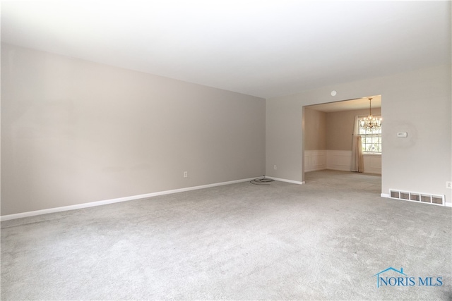 2214 Thornridge Dr, Toledo, OH 43614 - spare room featuring a chandelier, light colored carpet, and baseboards