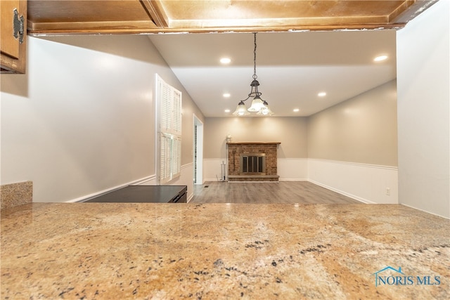 2214 Thornridge Dr, Toledo, OH 43614 - unfurnished living room featuring wood finished floors, recessed lighting, and a brick fireplace