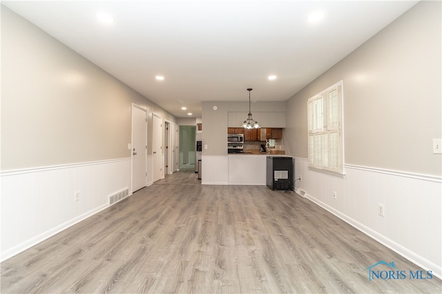 2214 Thornridge Dr, Toledo, OH 43614 - unfurnished living room featuring recessed lighting, light wood-type flooring, wainscoting, and a chandelier