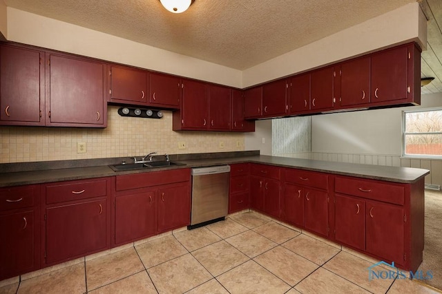 536 Edinborough Dr, Findlay, OH 45840 - kitchen featuring dishwasher, a sink, dark countertops, a textured ceiling, and red cabinets