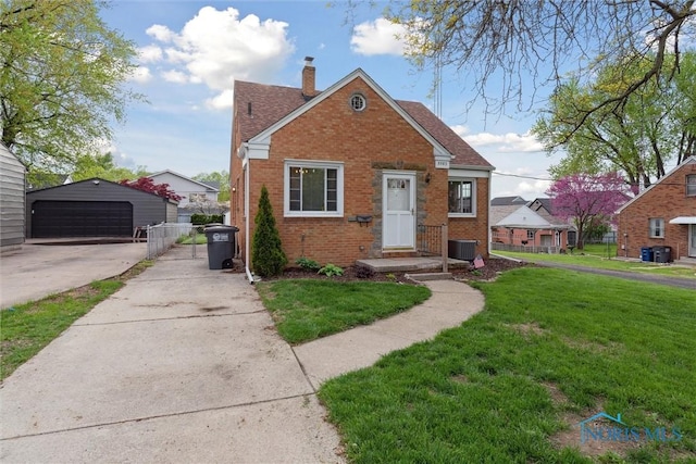 5583 304th St, Toledo, OH 43611 - bungalow with a chimney, an outbuilding, brick siding, cooling unit, and a front yard