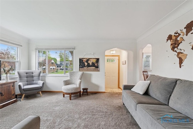 5583 304th St, Toledo, OH 43611 - carpeted living room with ornamental molding, a wealth of natural light, baseboards, and arched walkways