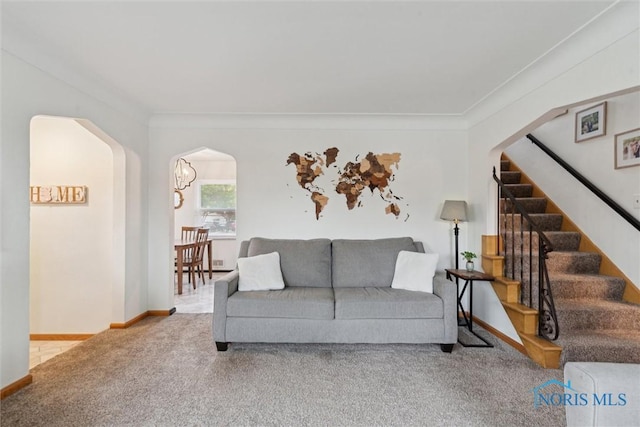5583 304th St, Toledo, OH 43611 - living room featuring carpet flooring, ornamental molding, stairway, and arched walkways