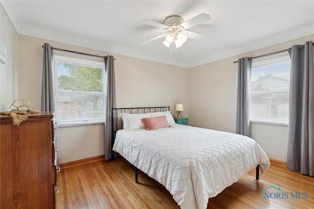 5583 304th St, Toledo, OH 43611 - bedroom with baseboards, light wood-style flooring, and ceiling fan