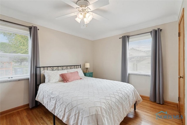 5583 304th St, Toledo, OH 43611 - bedroom with baseboards, multiple windows, ceiling fan, and wood finished floors