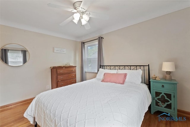 5583 304th St, Toledo, OH 43611 - bedroom featuring wood finished floors, baseboards, and ceiling fan