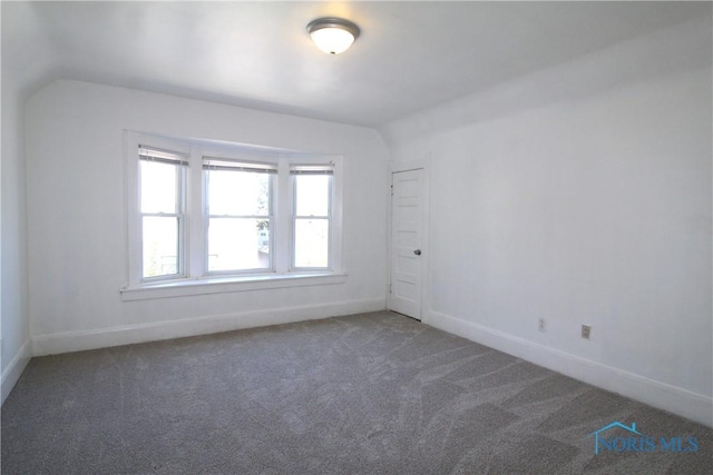 304 Dexter St, Toledo, OH 43608 - carpeted empty room with baseboards and vaulted ceiling