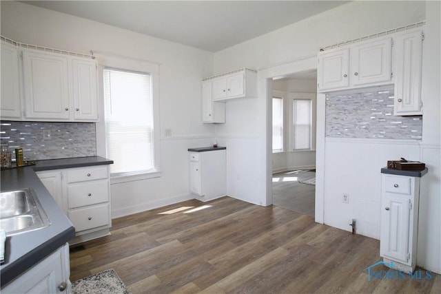 304 Dexter St, Toledo, OH 43608 - kitchen with dark countertops, backsplash, and white cabinetry