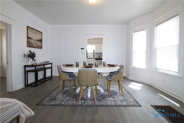 304 Dexter St, Toledo, OH 43608 - dining room with visible vents, baseboards, and wood finished floors