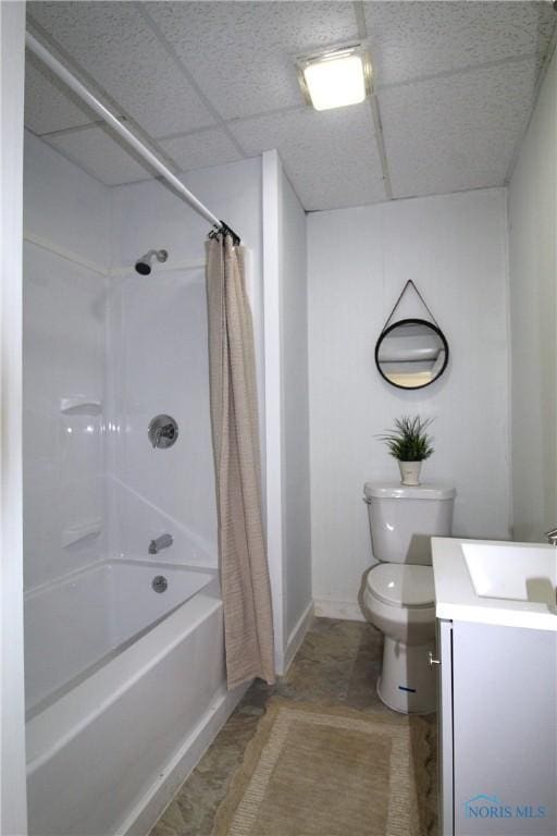 304 Dexter St, Toledo, OH 43608 - bathroom with toilet, vanity, baseboards, a paneled ceiling, and shower / bath combo
