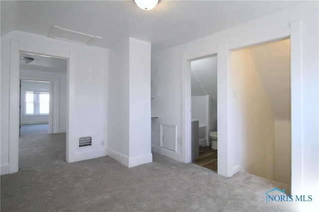 304 Dexter St, Toledo, OH 43608 - unfurnished bedroom featuring attic access, ensuite bathroom, visible vents, and carpet floors