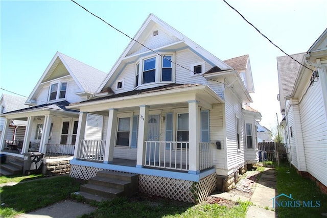 304 Dexter St, Toledo, OH 43608 - view of front of house featuring covered porch and fence
