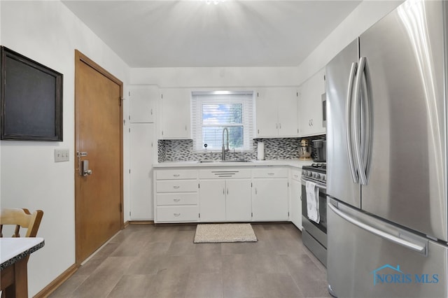 2710 131st St, Toledo, OH 43611 - kitchen featuring appliances with stainless steel finishes, a sink, light countertops, decorative backsplash, and white cabinets