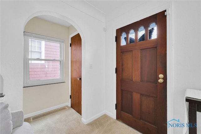2923 Powhattan Pkwy, Toledo, OH 43606 - entrance foyer with carpet, arched walkways, and baseboards