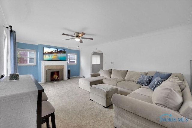 2923 Powhattan Pkwy, Toledo, OH 43606 - living room featuring a ceiling fan, carpet flooring, a fireplace, and arched walkways
