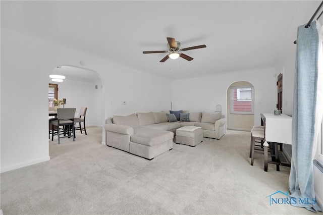 2923 Powhattan Pkwy, Toledo, OH 43606 - living area featuring arched walkways, a ceiling fan, carpet, and baseboards
