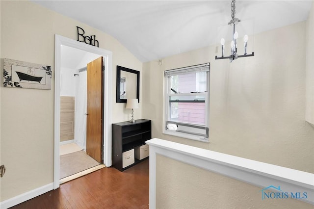 2923 Powhattan Pkwy, Toledo, OH 43606 - hall featuring vaulted ceiling, a chandelier, dark wood-type flooring, and baseboards