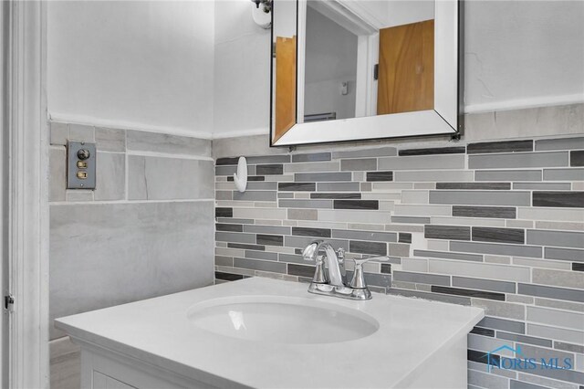 2923 Powhattan Pkwy, Toledo, OH 43606 - bathroom with backsplash, vanity, and tile walls
