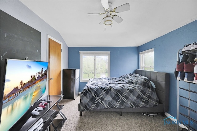 2923 Powhattan Pkwy, Toledo, OH 43606 - carpeted bedroom with freestanding refrigerator, a ceiling fan, and vaulted ceiling