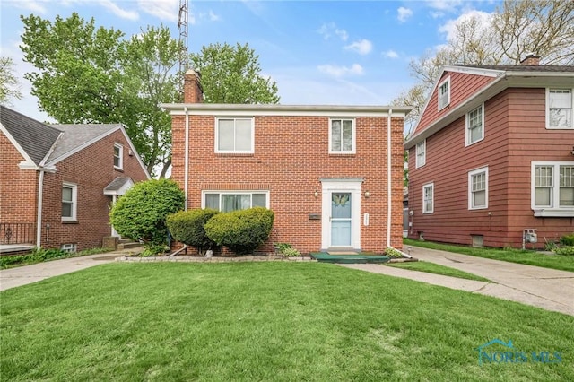 2923 Powhattan Pkwy, Toledo, OH 43606 - view of front of property with a chimney, a front lawn, and brick siding